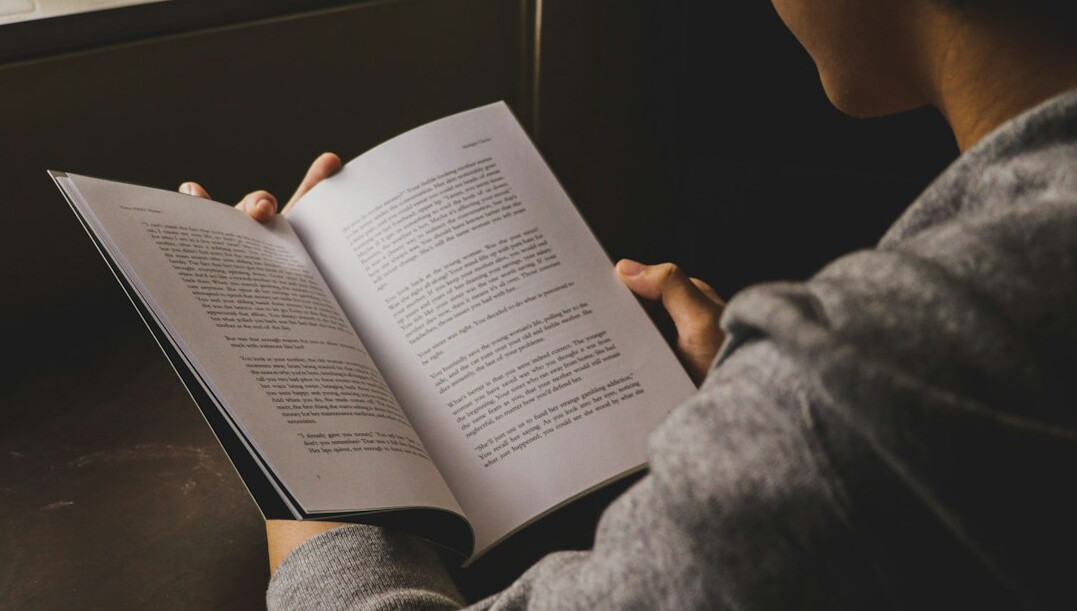 person reading self help book