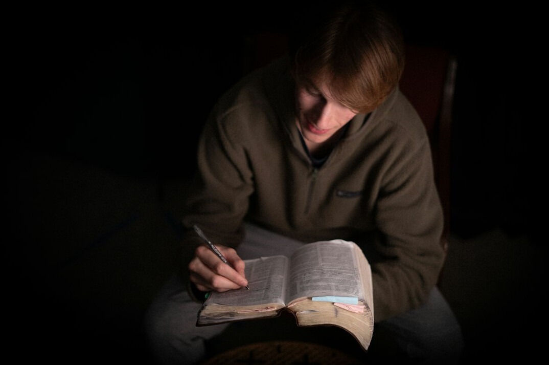 person reading book in quiet room